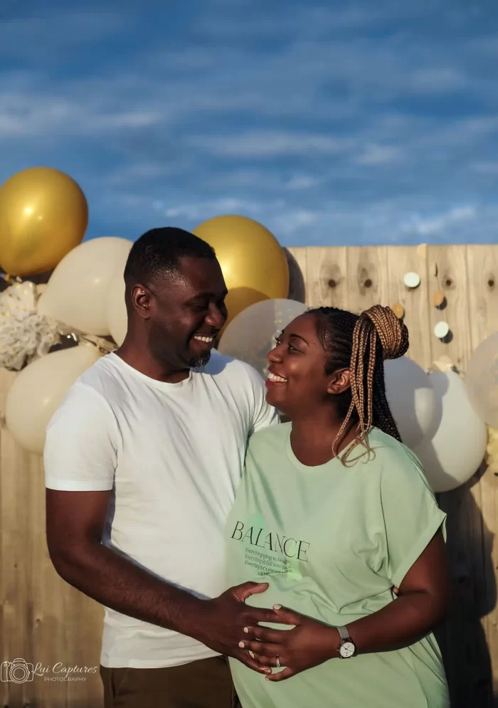 Smiling couple celebrating their pregnancy